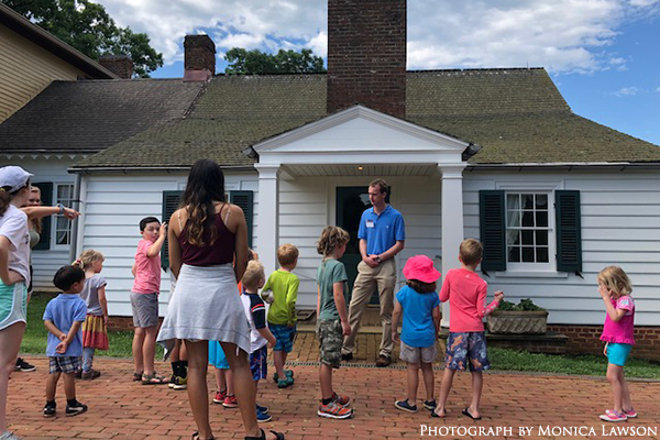 children listening to tour guide